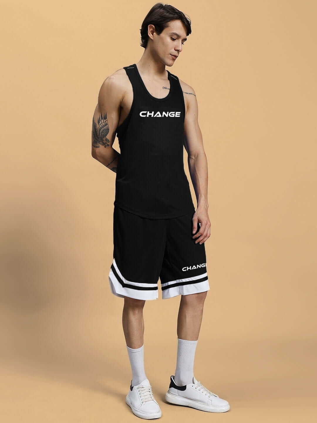 Model wearing black CHANGE YOUR LOOKS gym co-ord set, showcasing sporty polyester fabric with white accents, perfect for workouts.