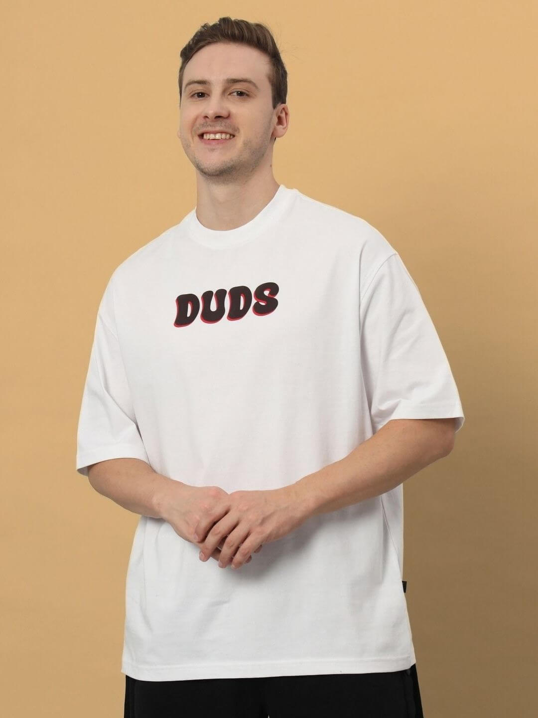 Man wearing a CARINO OVER-SIZED T-SHIRT WHITE in premium heavy gauge 100% cotton fabric.