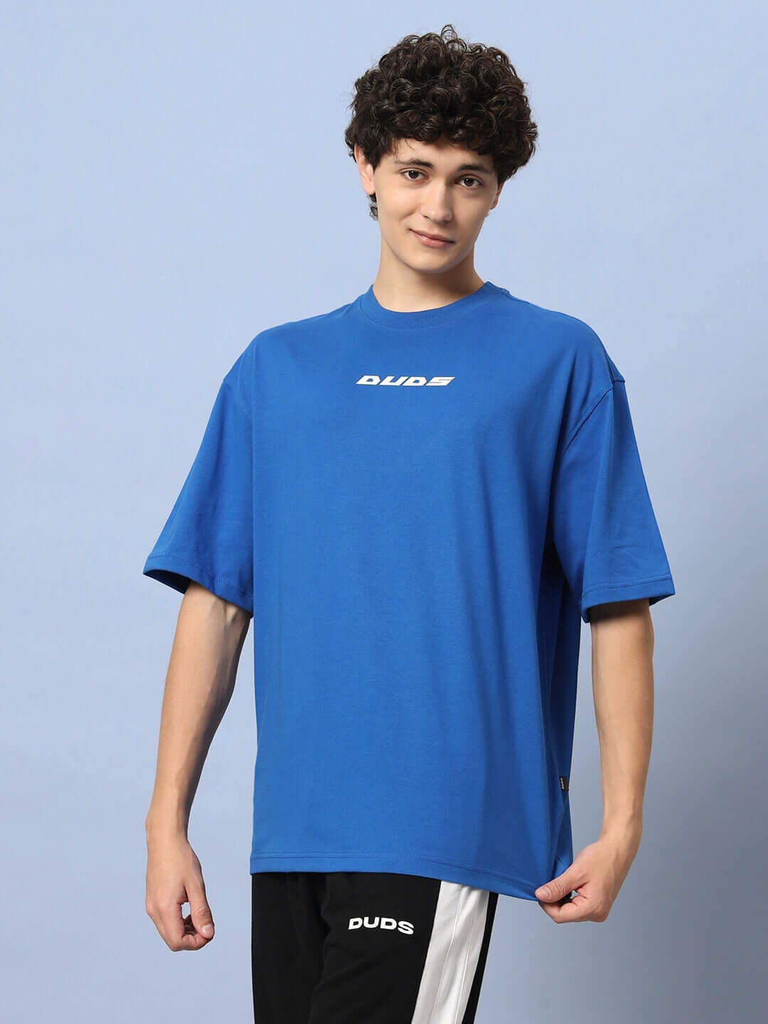 Model wearing LUNA OVER-SIZED T-SHIRT ROYAL BLUE, showing streetwear style with a relaxed fit and vibrant color.