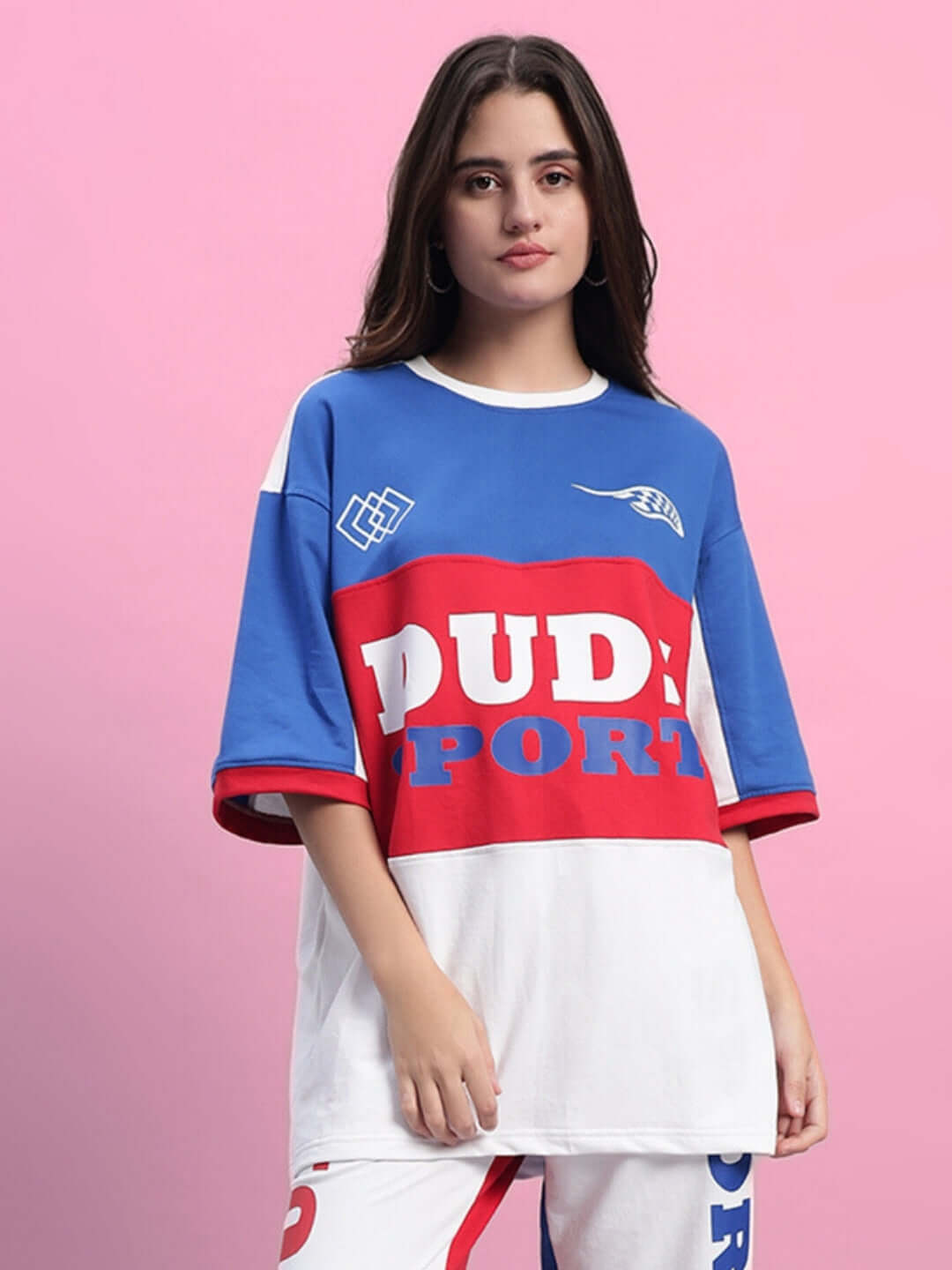 Model wearing women's oversized multi-color urban t-shirt with bold print, made of premium cotton blend, by Color By Colours.