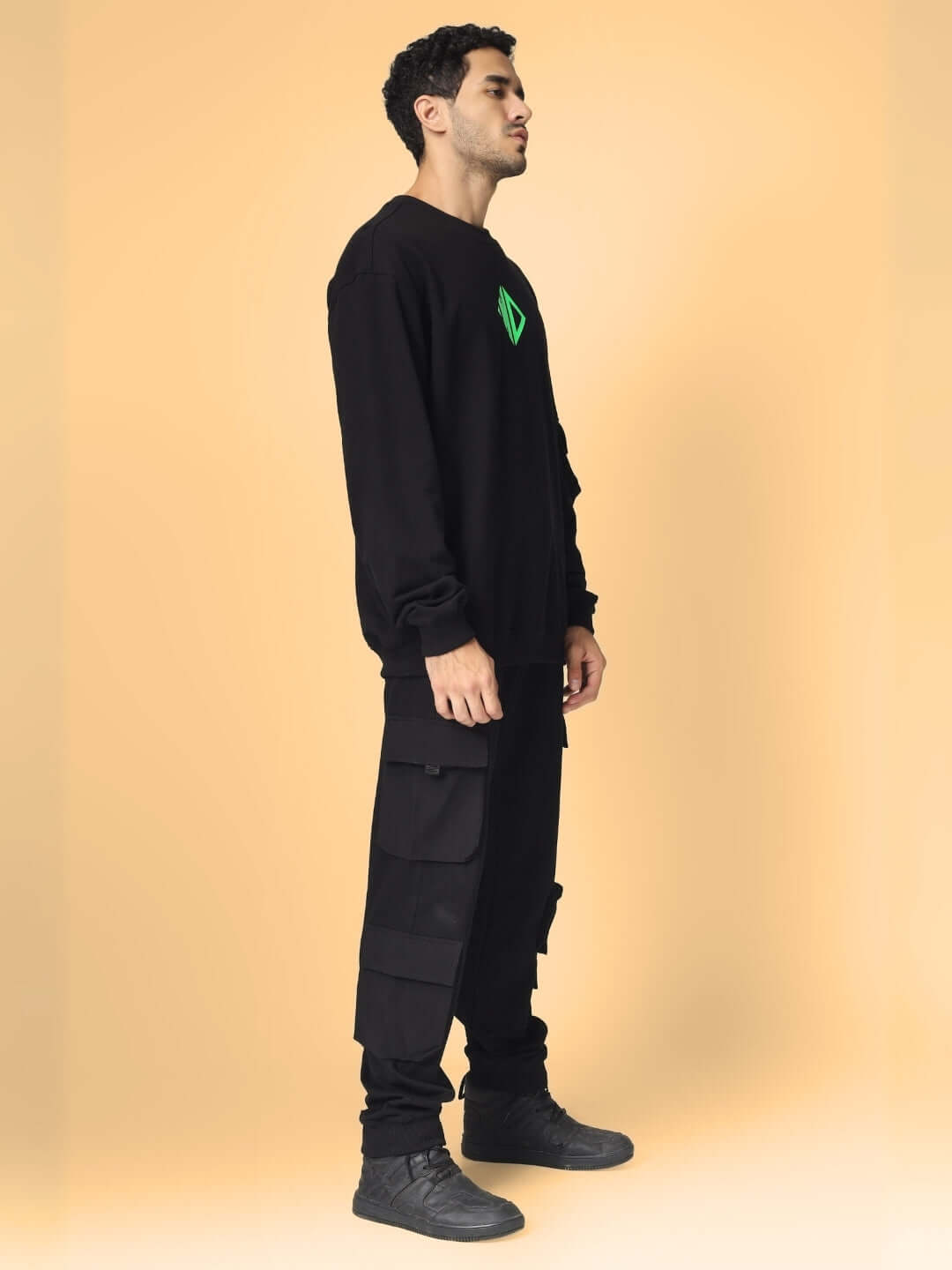 Model wearing oversized black cotton terry sweatshirt, side view. Made from premium 97% cotton French terry, 240 GSM bio-washed.