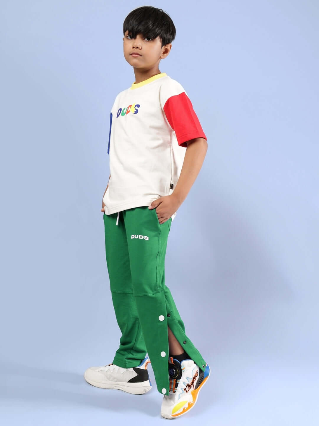 Child wearing ADONIS CO-ORD for boys and girls in off white and green by DUDS, showcasing vibrant outfit design.