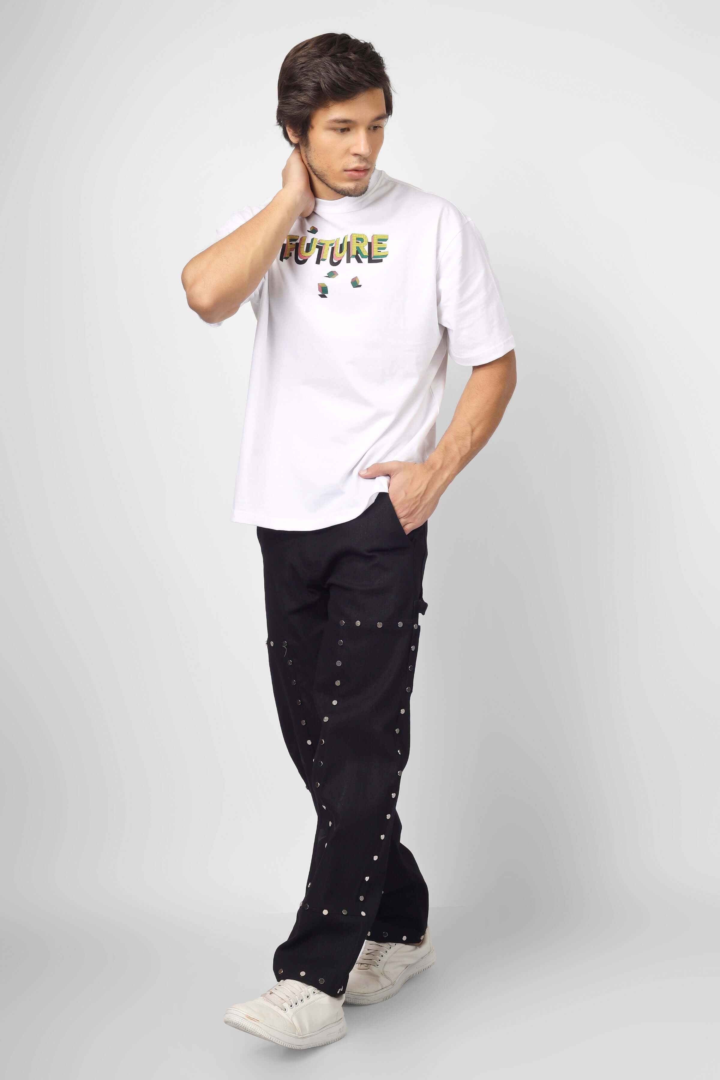 Man wearing 7 Pocket Multi Metal Stud Button Pants with white graphic tee, showcasing edgy fashion and ample storage.