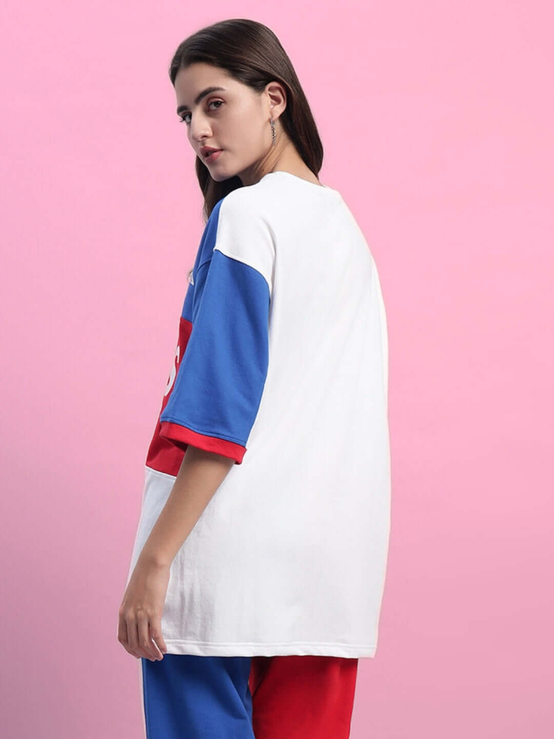 Model wearing women's urban drift over-sized t-shirt in multi colors with premium cotton fabric against pink background.