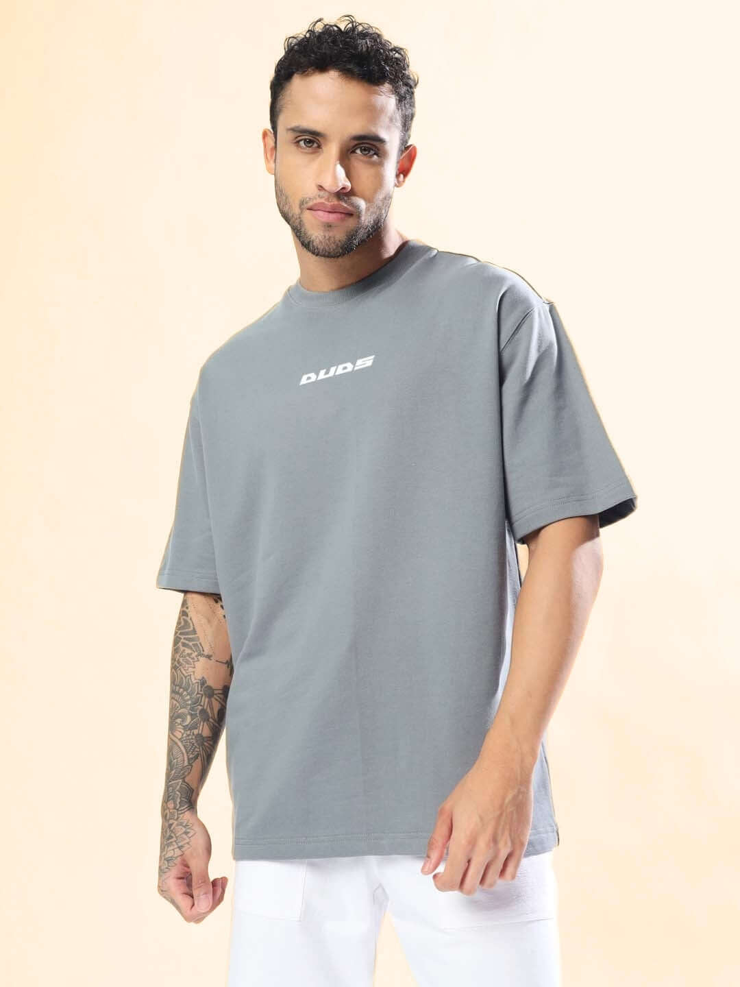 ONLY HOPE REMAINS OVER-SIZED T-SHIRT GREY on model, showcasing casual streetwear style with contemporary design.