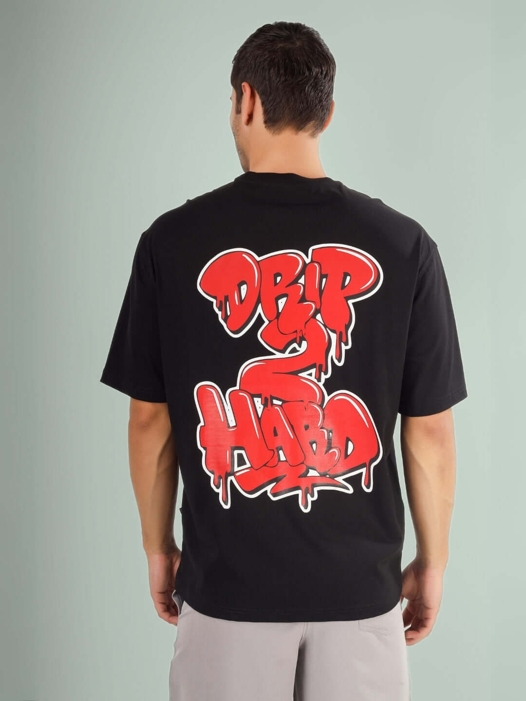 Back view of DRIP 2 HARD OVER-SIZED T-SHIRT BLACK with red graphic design.