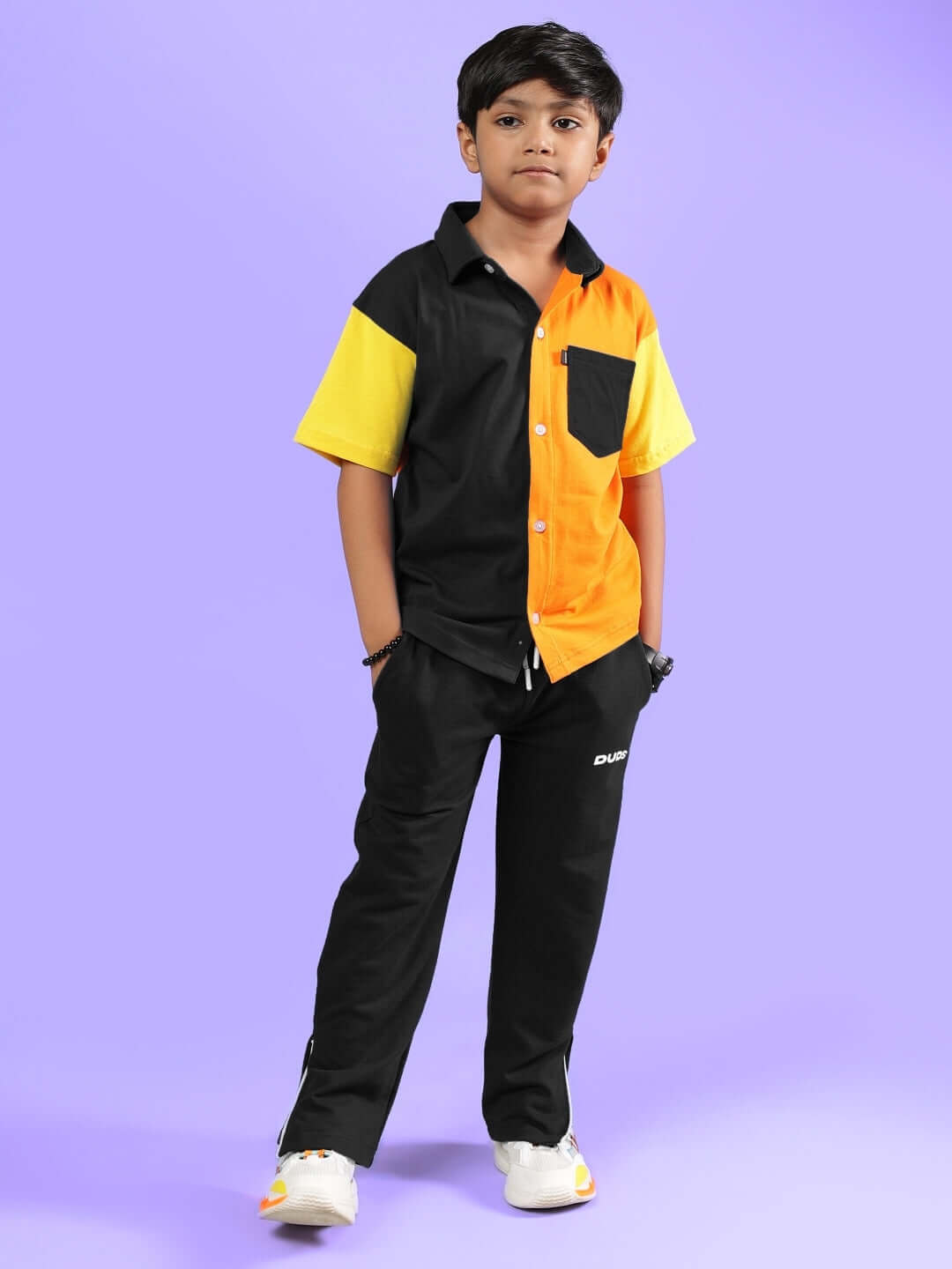 Child wearing APEX Co-Ord for Boys & Girls in Multi-Black with orange and yellow accents, made by DUDS.