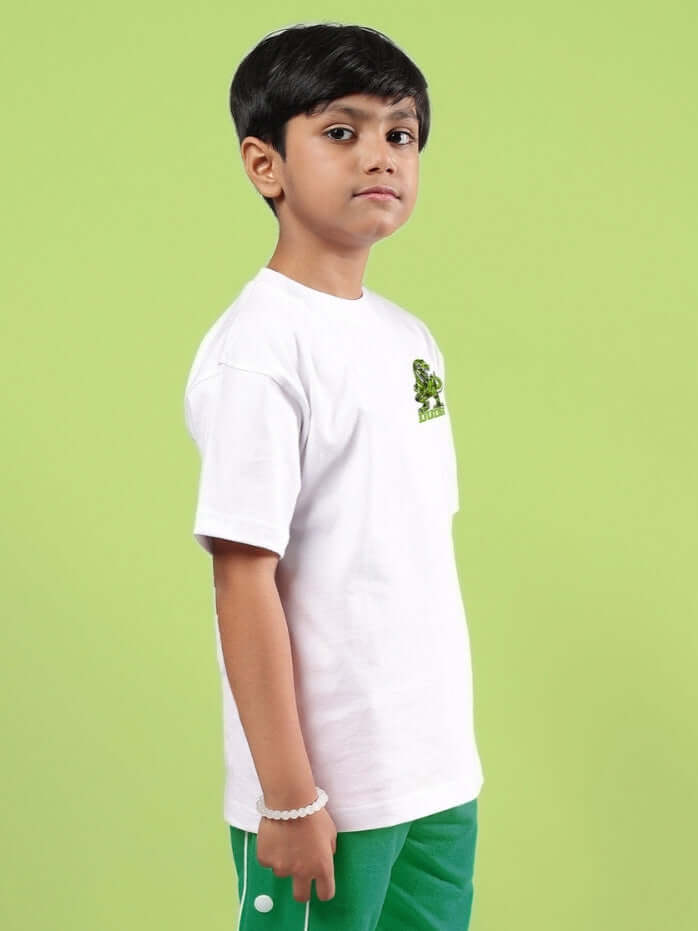 Child wearing ROBO REX oversized white t-shirt by DUDS against green background