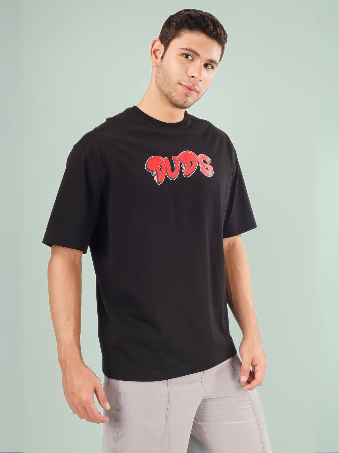 Man wearing DRIP 2 HARD OVER-SIZED T-SHIRT BLACK by DUDS