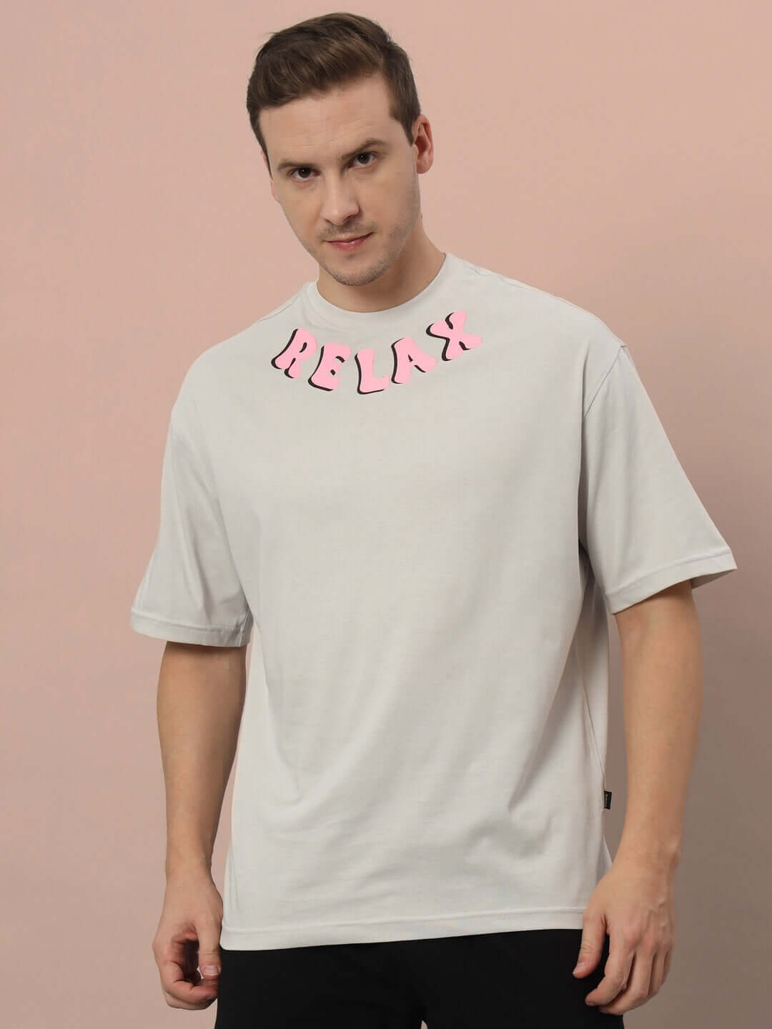 Model wearing FLOATING ROCK OVER-SIZED T-SHIRT GREY with 'RELAX' text, made from premium heavy gauge fabric, 100% cotton, bio-washed.