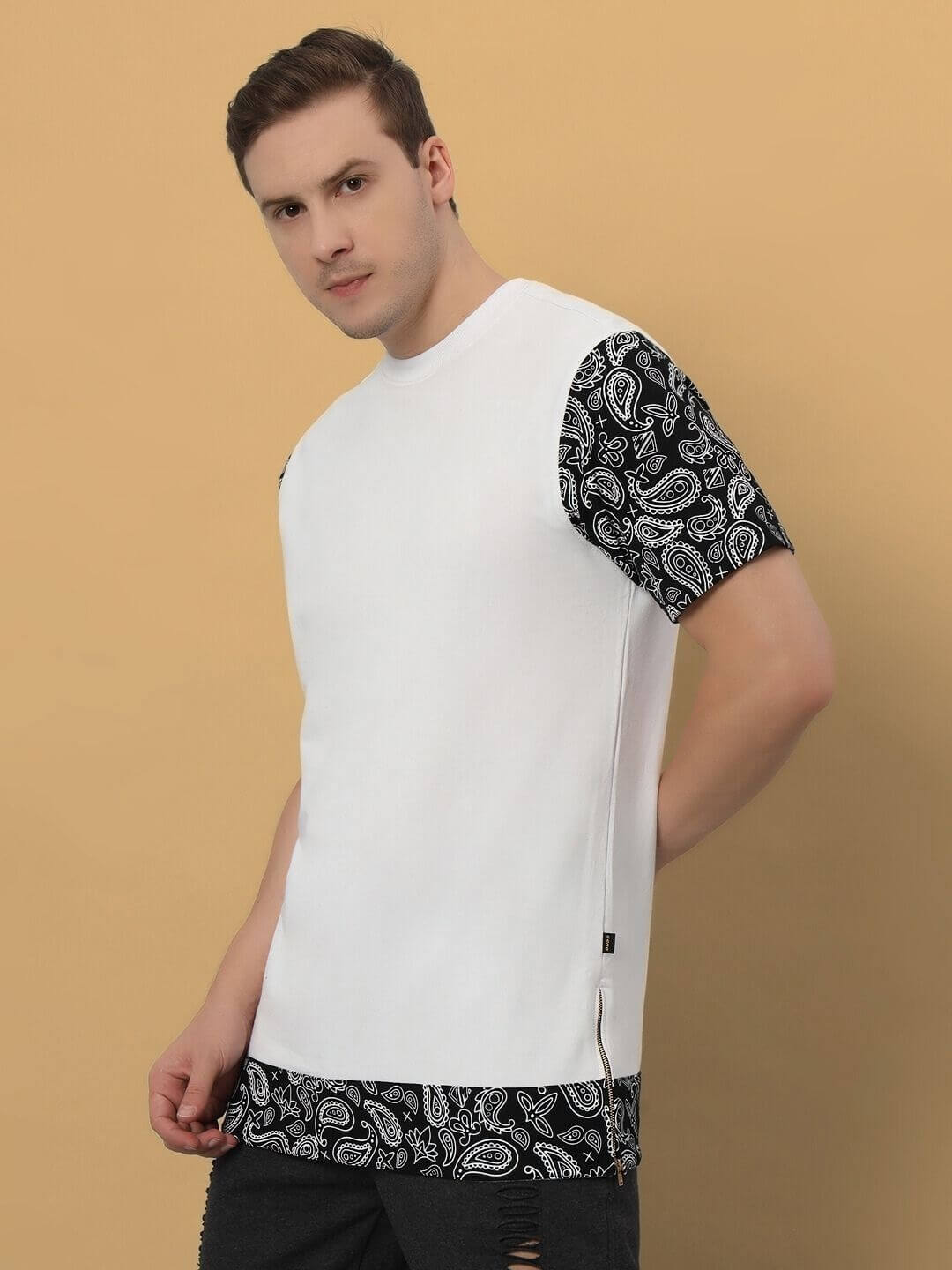 BEASLEY over-sized white T-shirt with black paisley sleeves, made of premium cotton French terry, worn by model against a beige background.