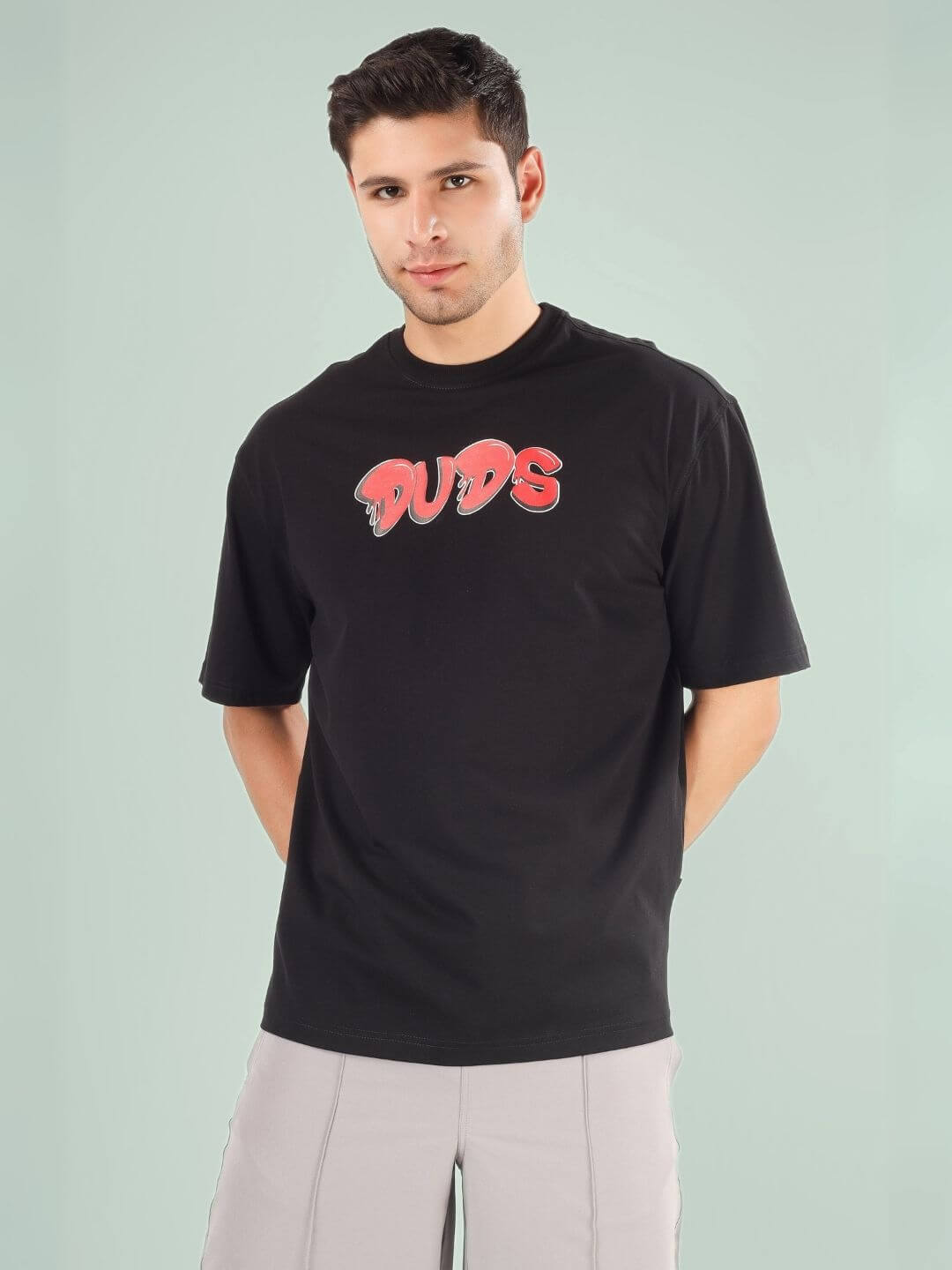 Man wearing DRIP 2 HARD OVER-SIZED T-SHIRT BLACK by DUDS