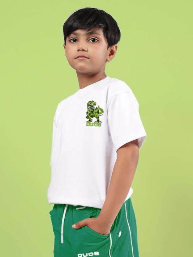 Boy wearing a white ROBO REX oversized T-shirt by DUDS, designed for both boys and girls, set against a green background.