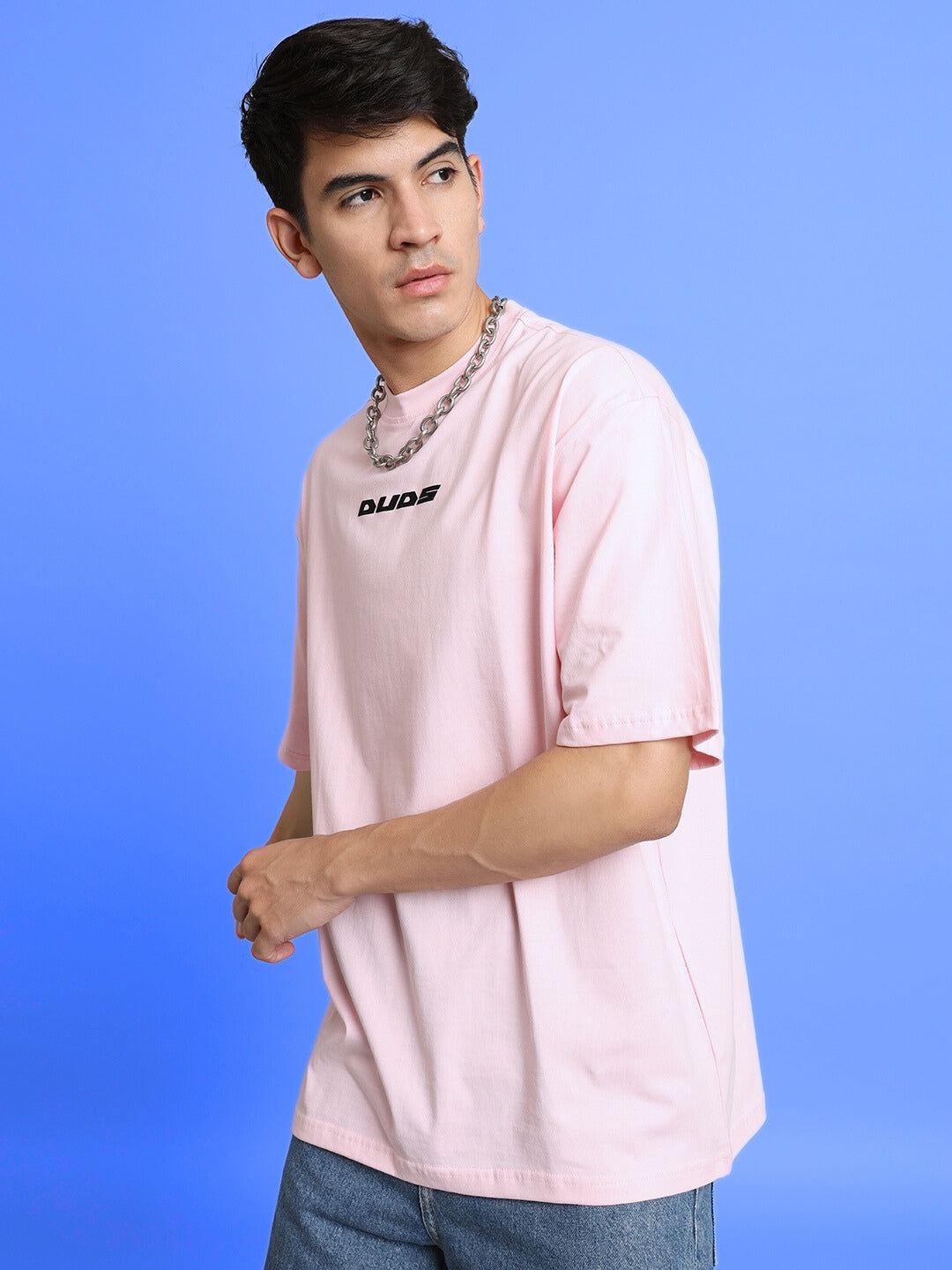 Model wearing TOP-DOG oversized pink T-shirt by DUDS, shown with chain necklace. Choose 'Custom Fit' for tailored sizes.