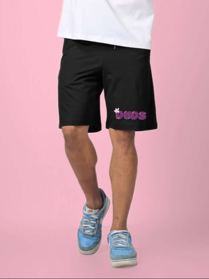 Man wearing NO POS SUMMER SHORTS in black from DUDS, showcasing casual style and personalized fit customization option.