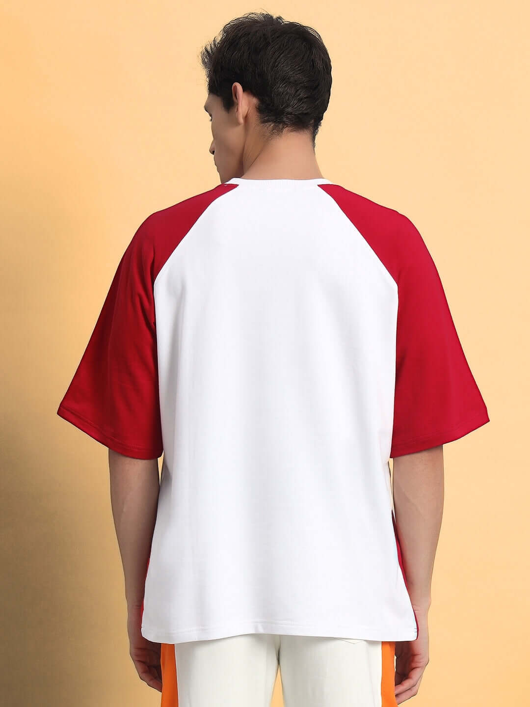 Back view of red and white NEVER GIVE UP OVERSIZED T-SHIRT RED, featuring premium heavy gauge fabric, perfect for casual wear.
