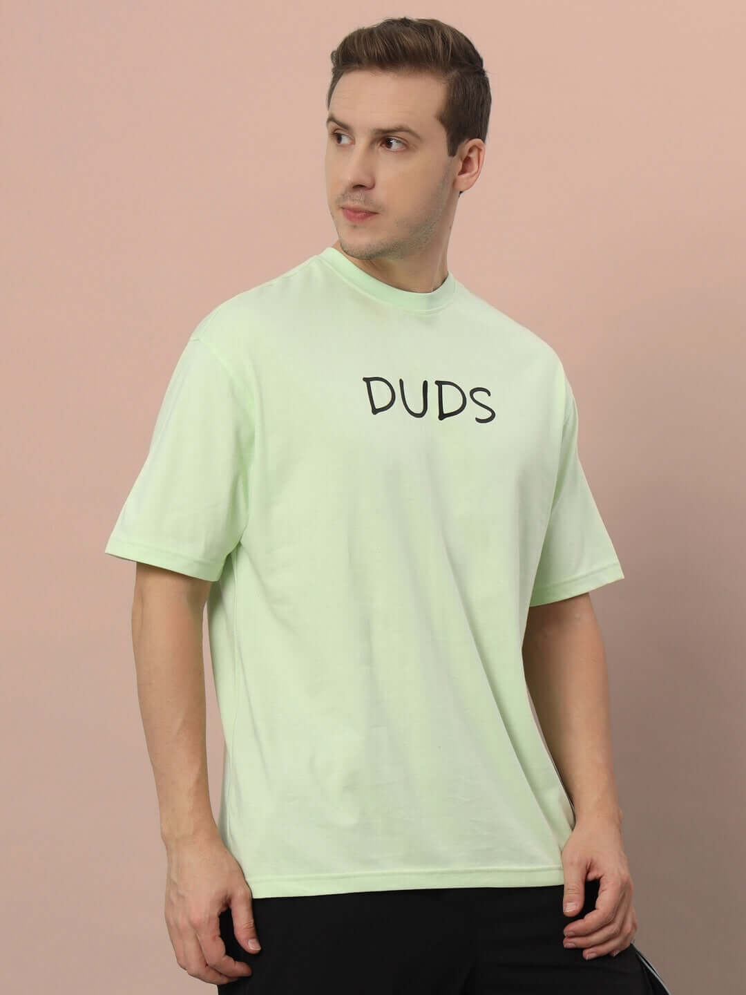 Man wearing DRINK JUICE OVER-SIZED T-SHIRT CELERY ICE with playful streetwear style