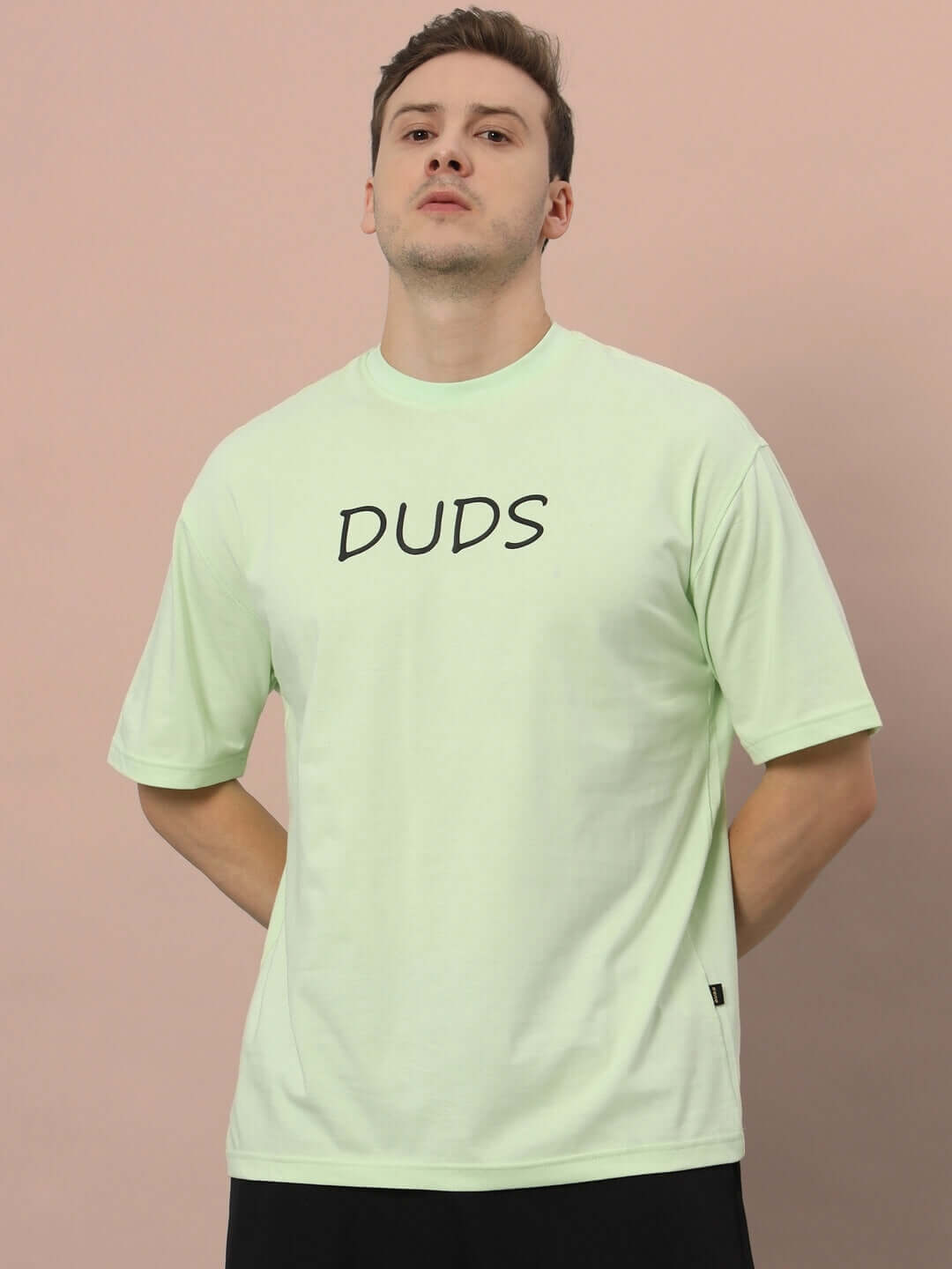 Model wearing DRINK JUICE OVER-SIZED T-SHIRT CELERY ICE in soft celery ice hue