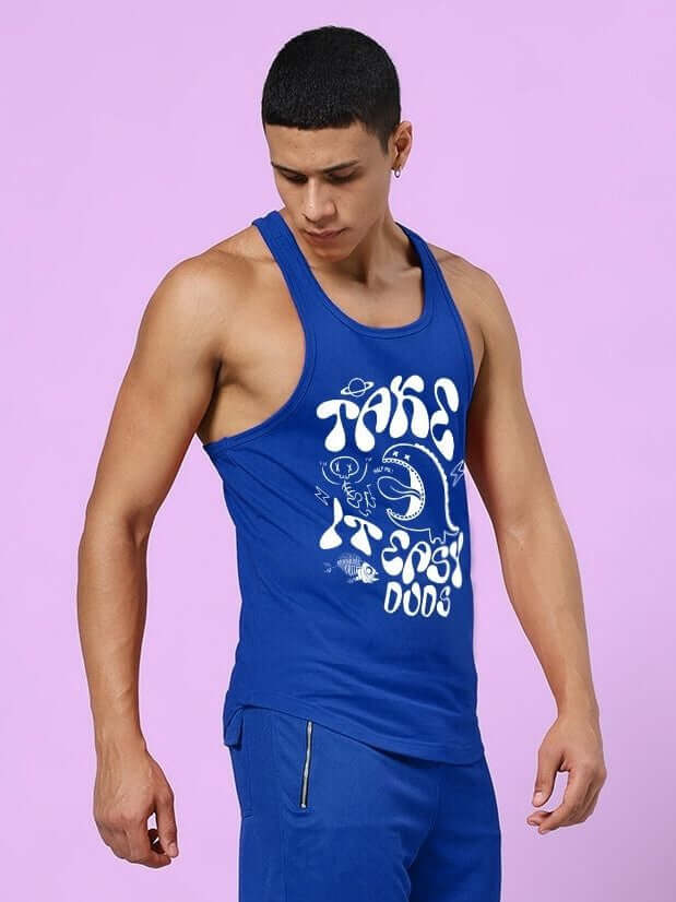 Model wearing TAKE IT EASY GYM VEST T-SHIRT BLUE with stylish print, perfect for workouts and casual wear.