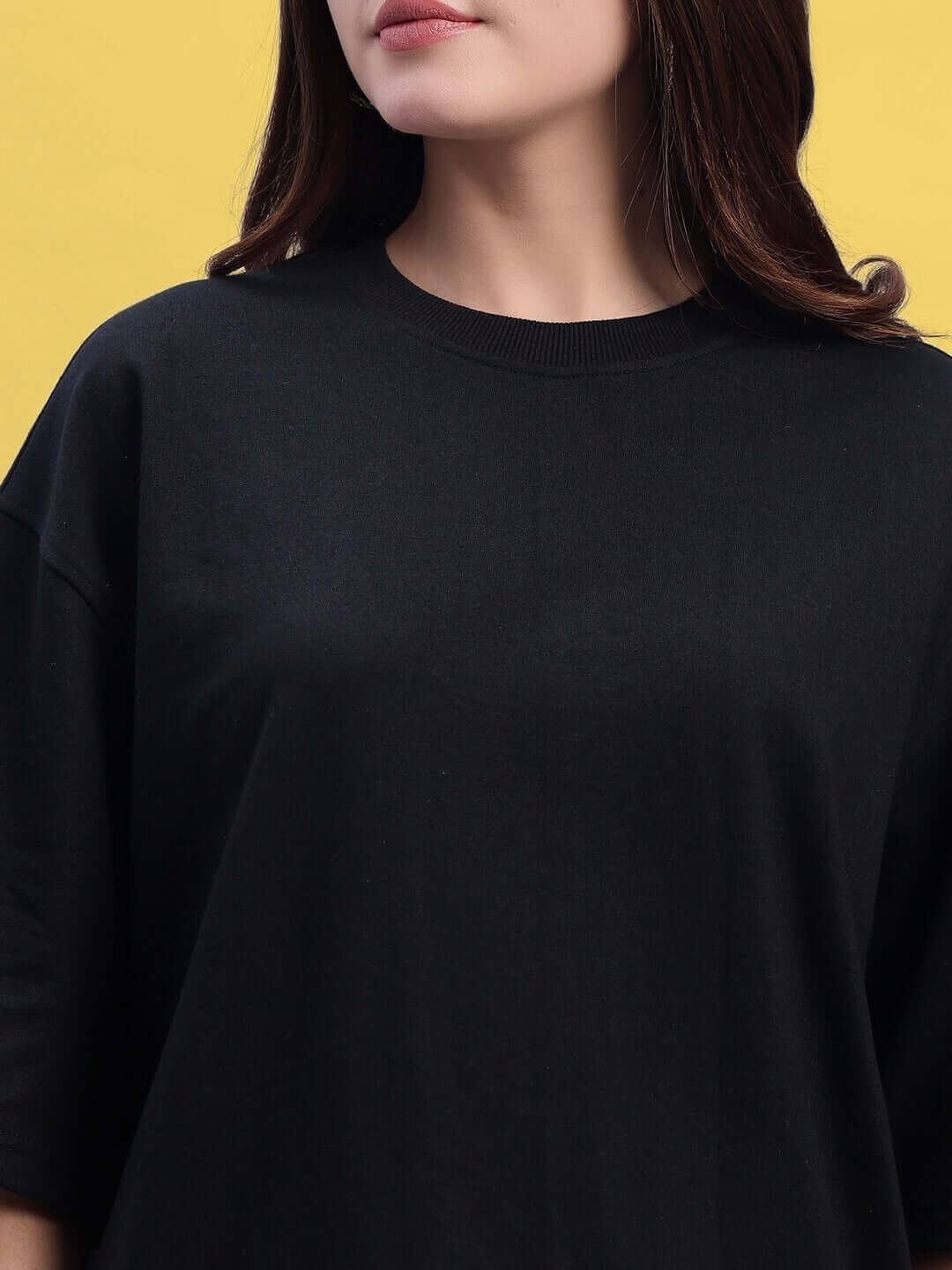 Women's Titan oversized T-shirt in black-red, made from premium heavy gauge fabric, showcasing a relaxed fit on a yellow background.