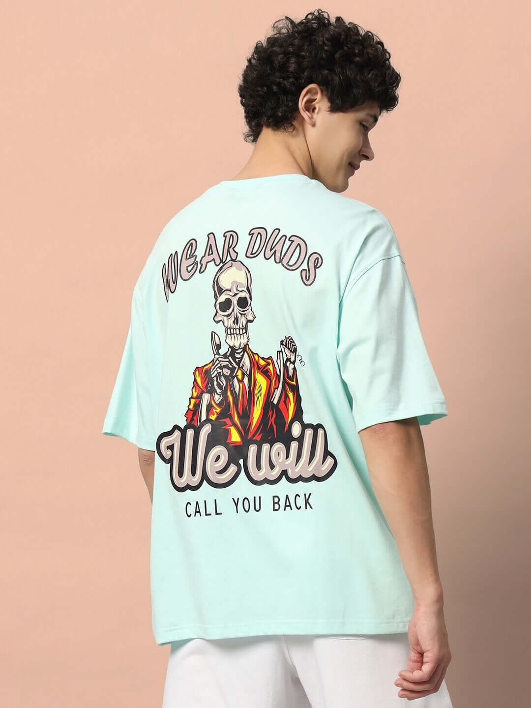 Model wearing CALL YOU BACK OVER-SIZED T-SHIRT ICE BLUE with a colorful design on the back.