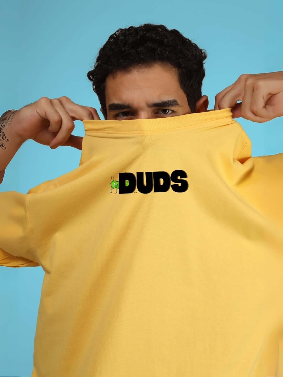 Model wearing LOCUST OVER-SIZED T-SHIRT YELLOW from DUDS, customizable fit option available.