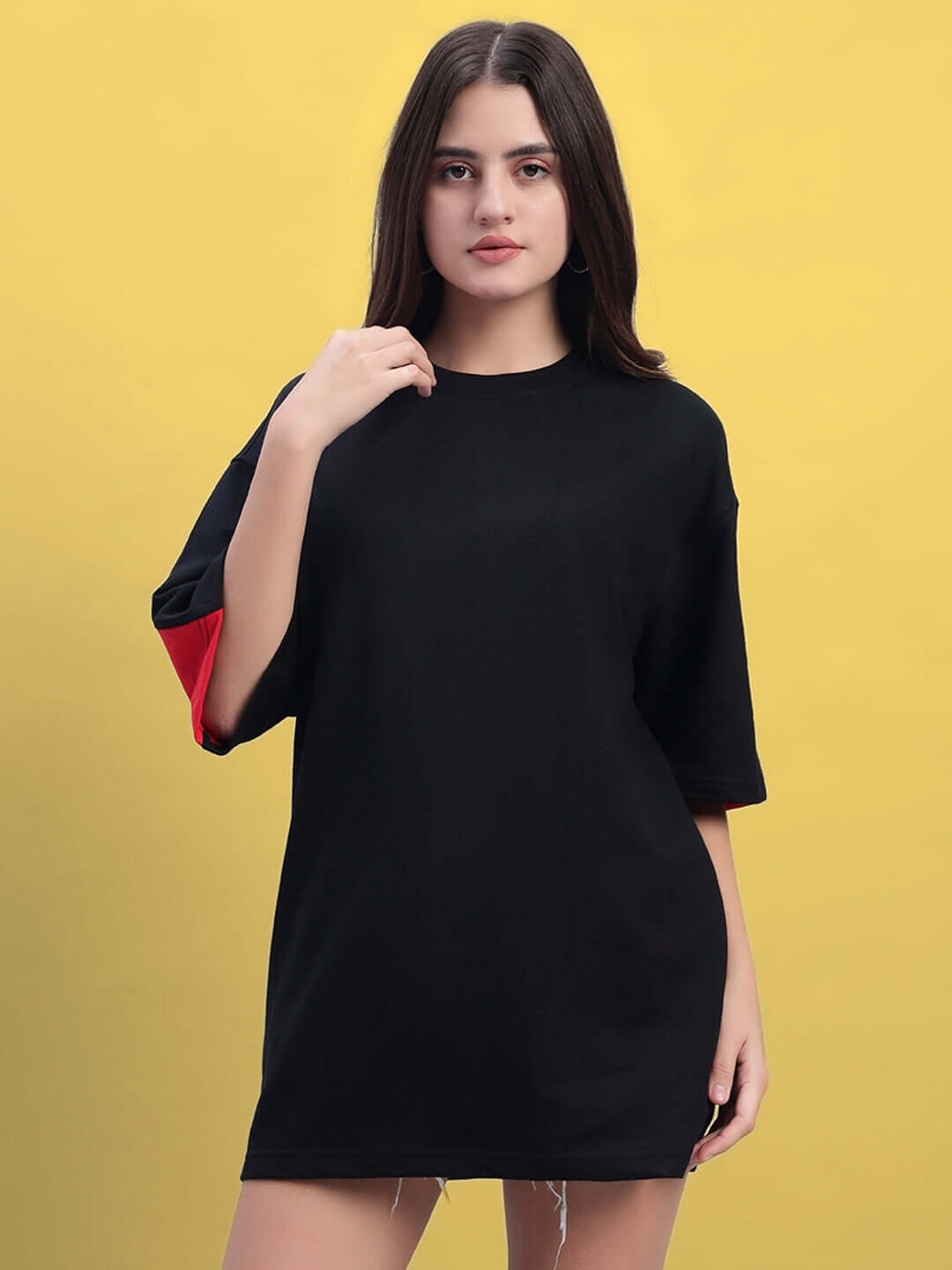 Woman wearing a black and red oversized Titan t-shirt made of premium cotton fabric.
