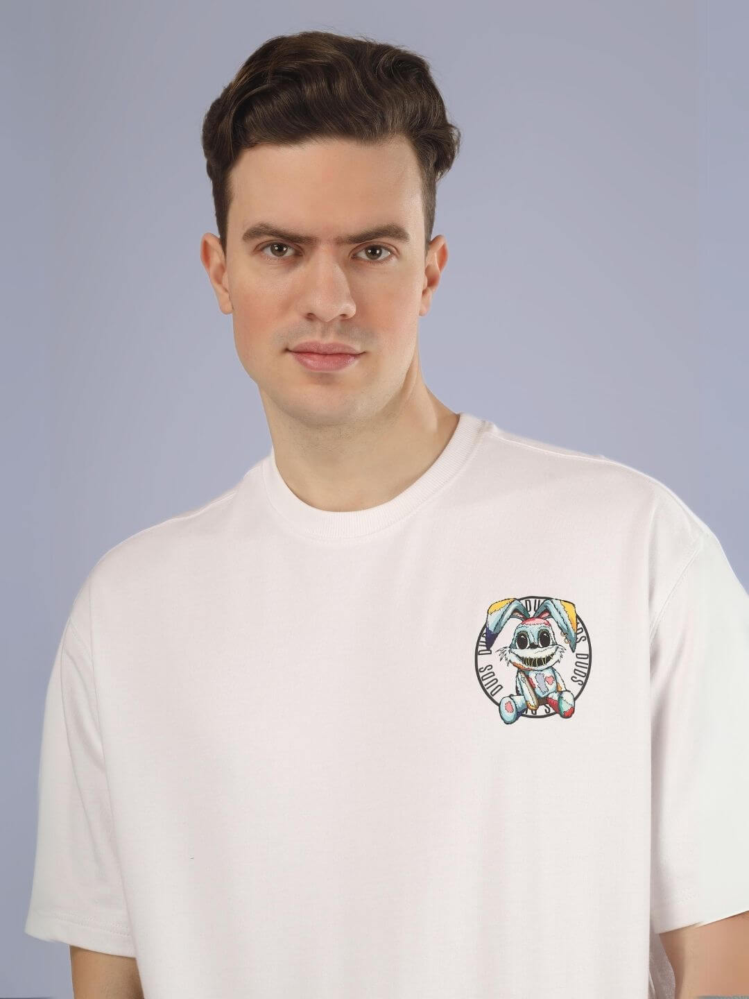 Man wearing "A Doll Not Rabbit" oversized printed t-shirt in white, featuring a unique design on a relaxed fit, 100% cotton tee.