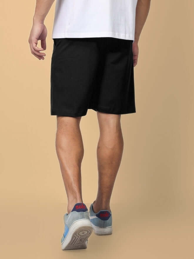 Man wearing FULNESS PARADISE Summer Shorts in black, showcasing customizable fit options for a tailored style.