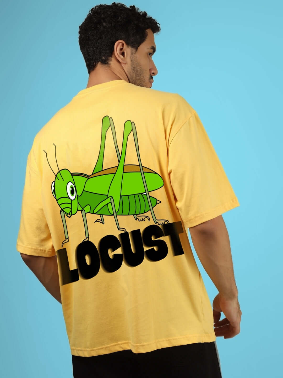 LOCUST OVER-SIZED T-SHIRT YELLOW with large green locust graphic on back, worn by model