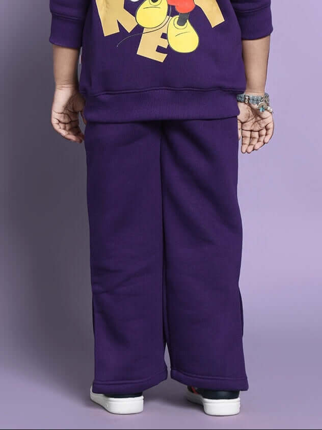 Child wearing purple Miller co-ord set for boys and girls, featuring playful graphic design.