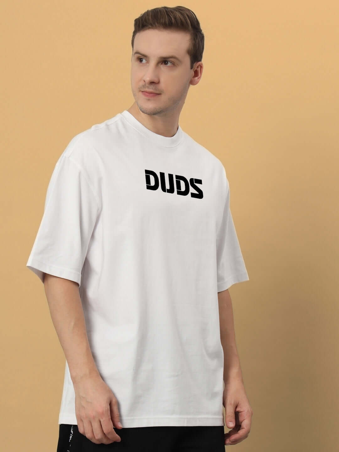 Model wearing LIVING THE LIFE OVER-SIZED T-SHIRT WHITE, featuring premium heavy gauge fabric and 100% cotton 200 GSM bio-washed material.