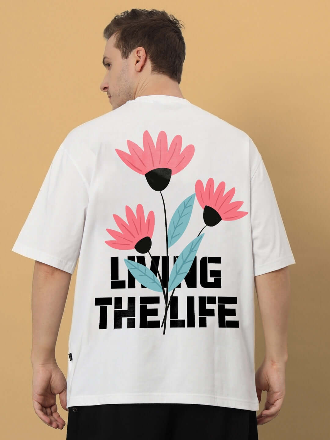 LIVING THE LIFE OVER-SIZED T-SHIRT WHITE with floral graphic, premium heavy gauge fabric, 100% cotton, shown on a model's back.