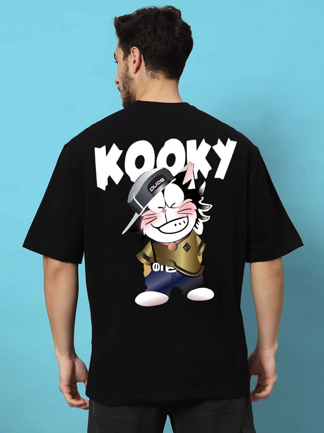 Man wearing KOOKY OVER-SIZED T-SHIRT BLACK featuring cartoon graphic on back in premium cotton fabric.