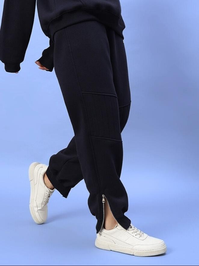 Women's navy blue Fight Night fleece jogger showing side zipper and casual style with white sneakers, perfect for cozy wear.