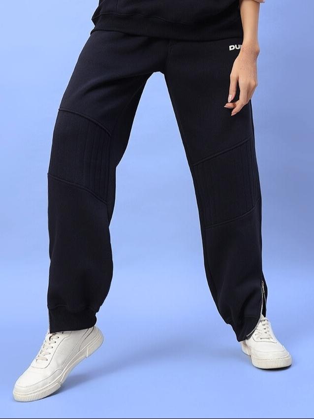 Women's Fight Night Fleece Jogger in navy blue, perfect for comfort and style. Shown with white sneakers on a blue background.