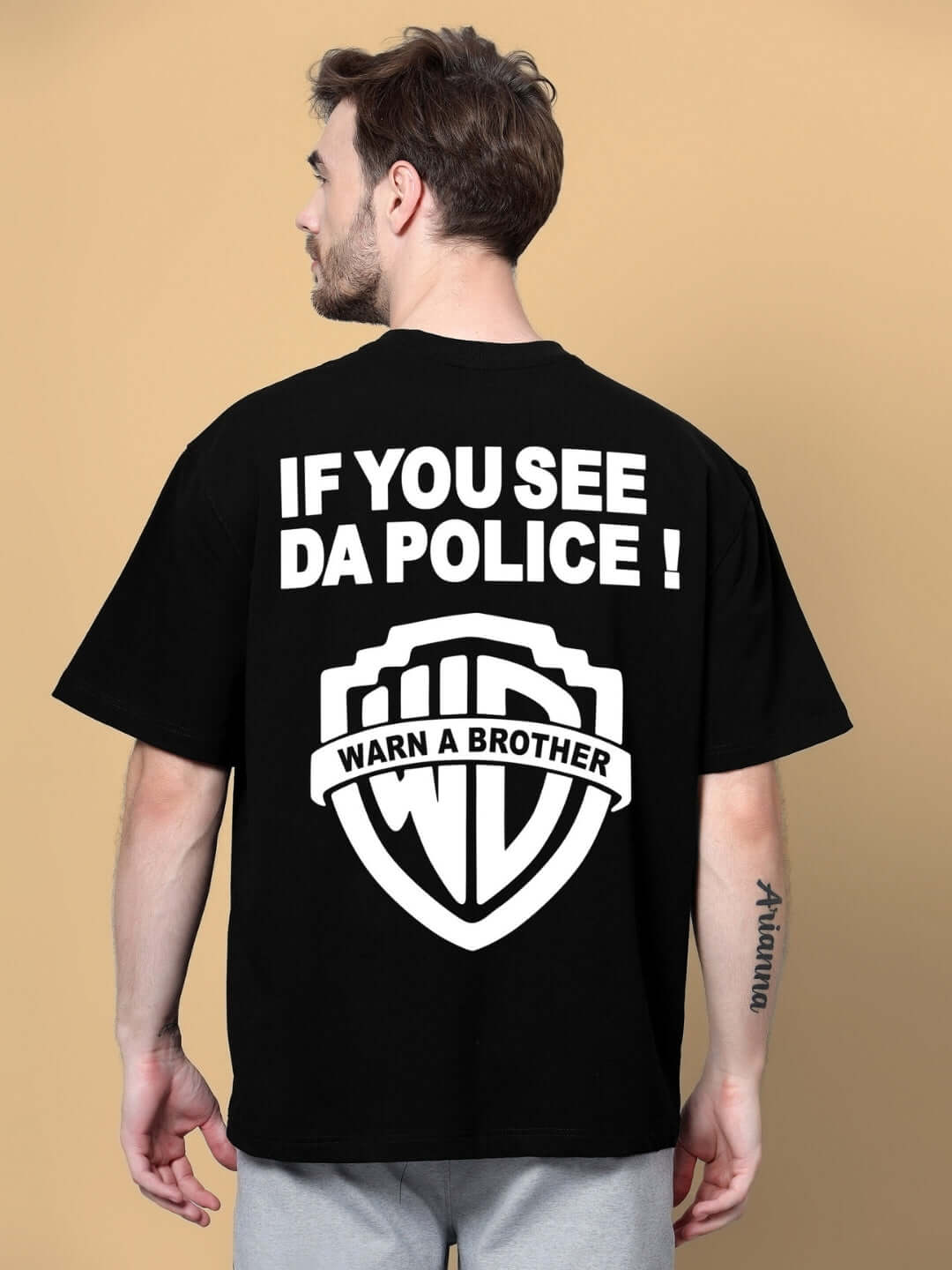 Back view of POLICIA OVER-SIZED T-SHIRT BLACK with humorous graphic and text.