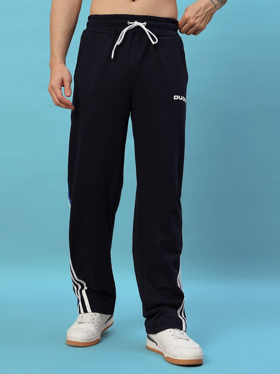 Navy blue TANGLE relaxed-fit joggers with drawstring waist, made to order by DUDS, featuring white stripe details on the legs.