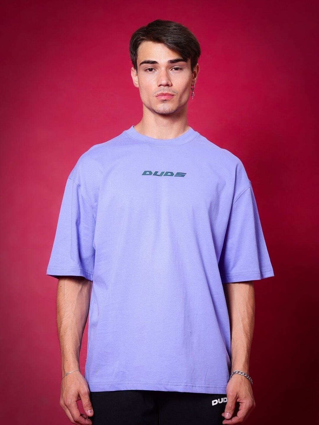 Model wearing BREATHE OVER-SIZED T-SHIRT PERIWINKLE against red background