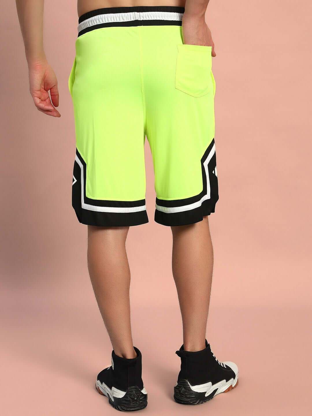 Back view of neon green ARMADO regular fit shorts with custom fit option.