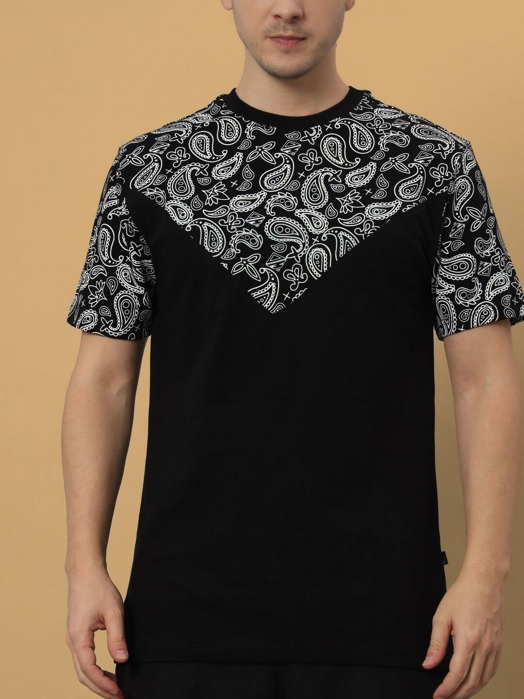Model wearing black Balladeer over-sized t-shirt with paisley pattern, made from premium cotton blend, ideal for stylish casual wear.