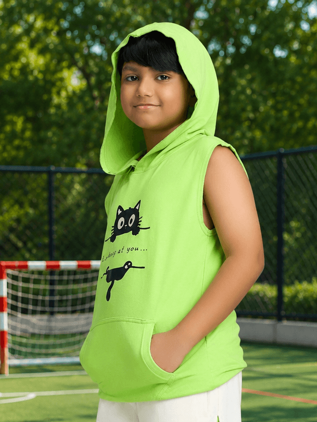 CURIOUS CAT HOODED T-SHIRT FOR BOYS GIRLS NEON GREEN worn by a smiling boy on a sports court, showcasing playful design.