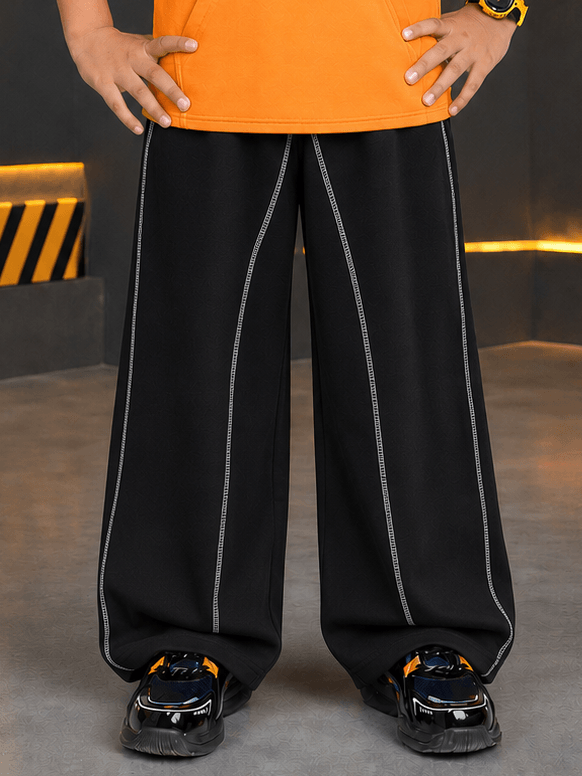 BEAT MODE JOGGER FOR BOYS GIRLS BLACK displayed on a child wearing an orange top and sporty shoes.