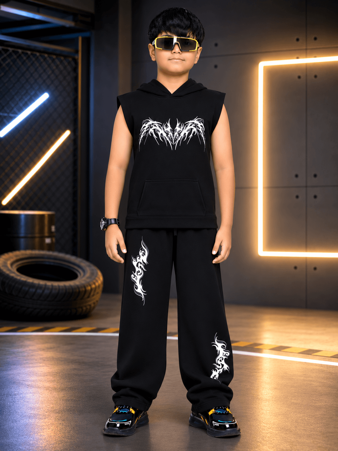 PHANTOM SLEEVELESS HOODED CO-ORD FOR BOYS GIRLS BLACK worn by a stylish boy in trendy streetwear, showcasing modern design.
