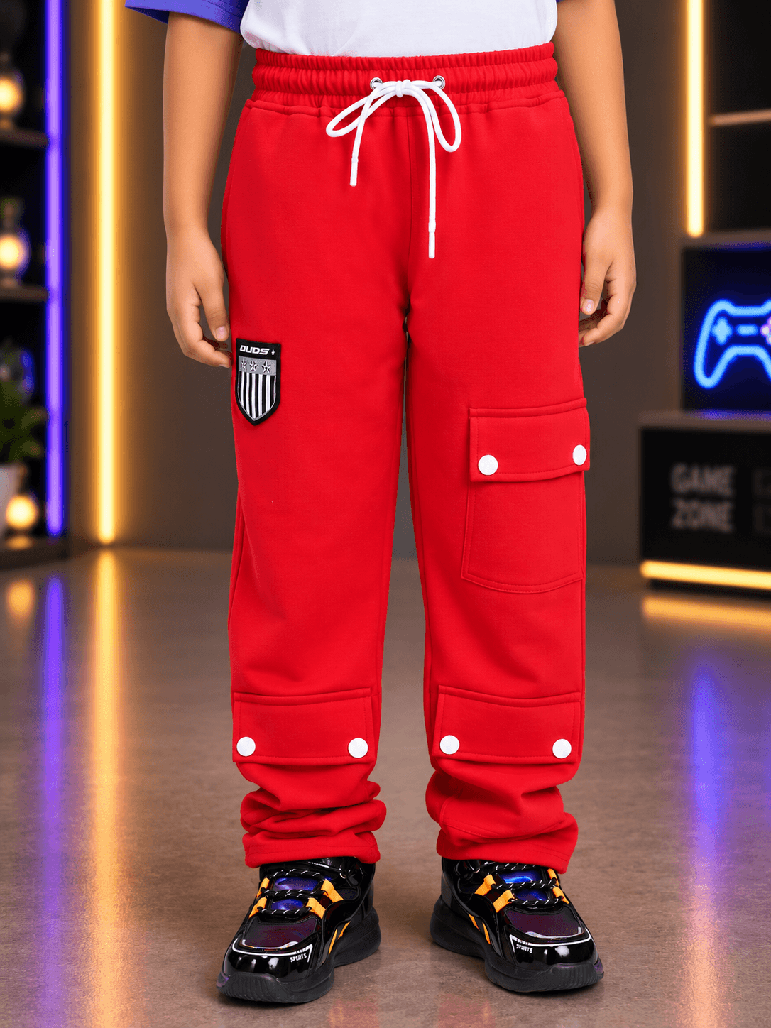 AWESOME FLAP POCKET BAGGY JOGGER FOR BOYS GIRLS RED worn by a child, showcasing its stylish design and flap pockets.