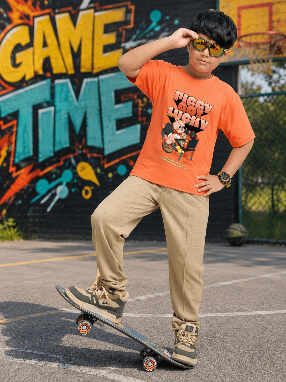 COMIC STREET JOGGER FOR BOYS GIRLS BEIGE worn by a boy skateboarding in a vibrant outdoor setting.