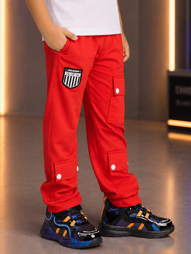 AWESOME FLAP POCKET BAGGY JOGGER FOR BOYS GIRLS RED worn by a child featuring flap pockets and stylish black sneakers.