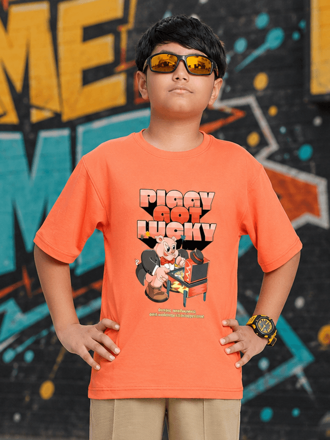 COMIC STREET T-SHIRT FOR BOYS GIRLS ORANGE worn by a boy with sunglasses against a colorful graffiti background.