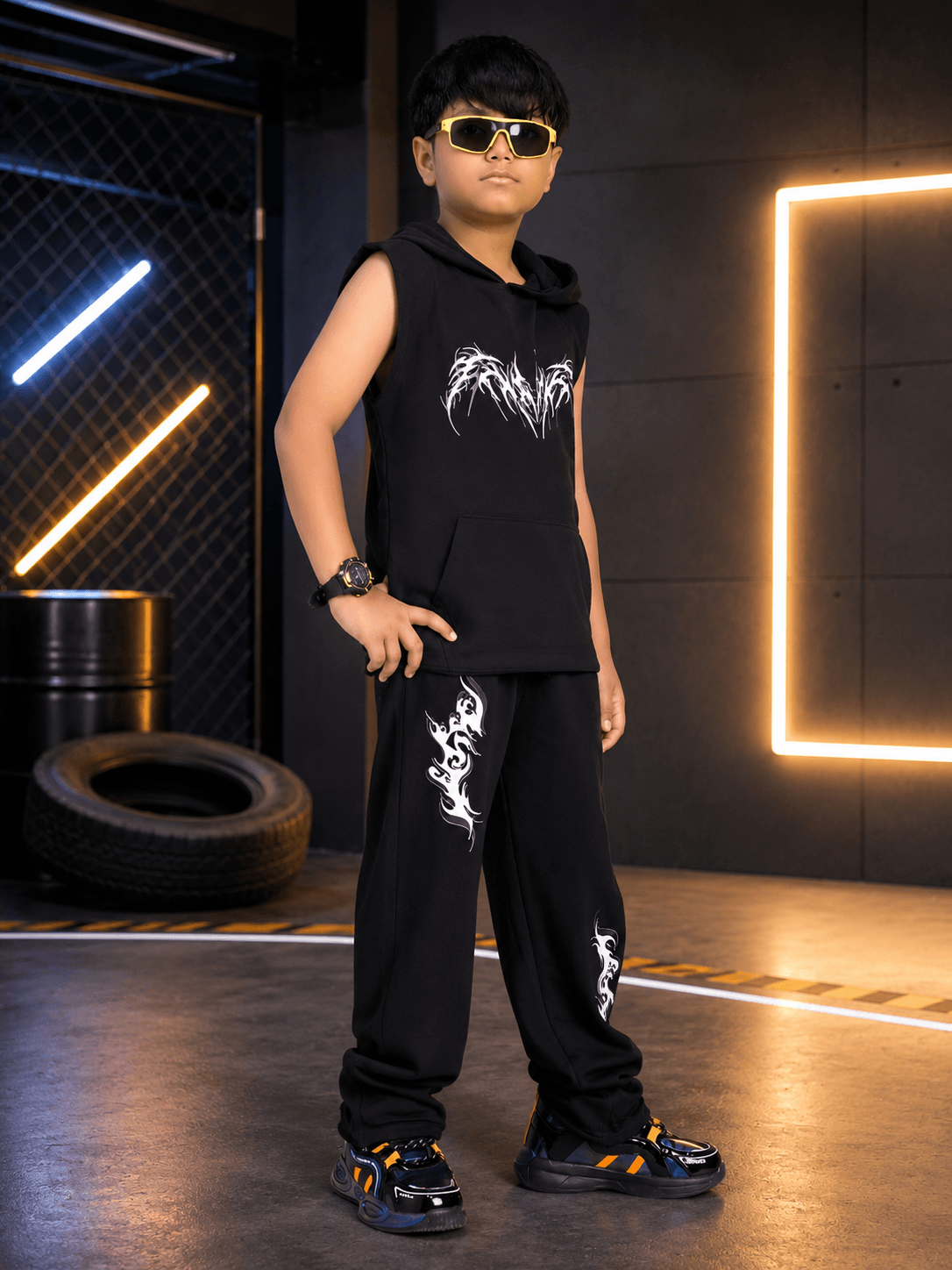 PHANTOM SLEEVELESS HOODED CO-ORD FOR BOYS GIRLS BLACK worn by a child in a stylish urban setting.