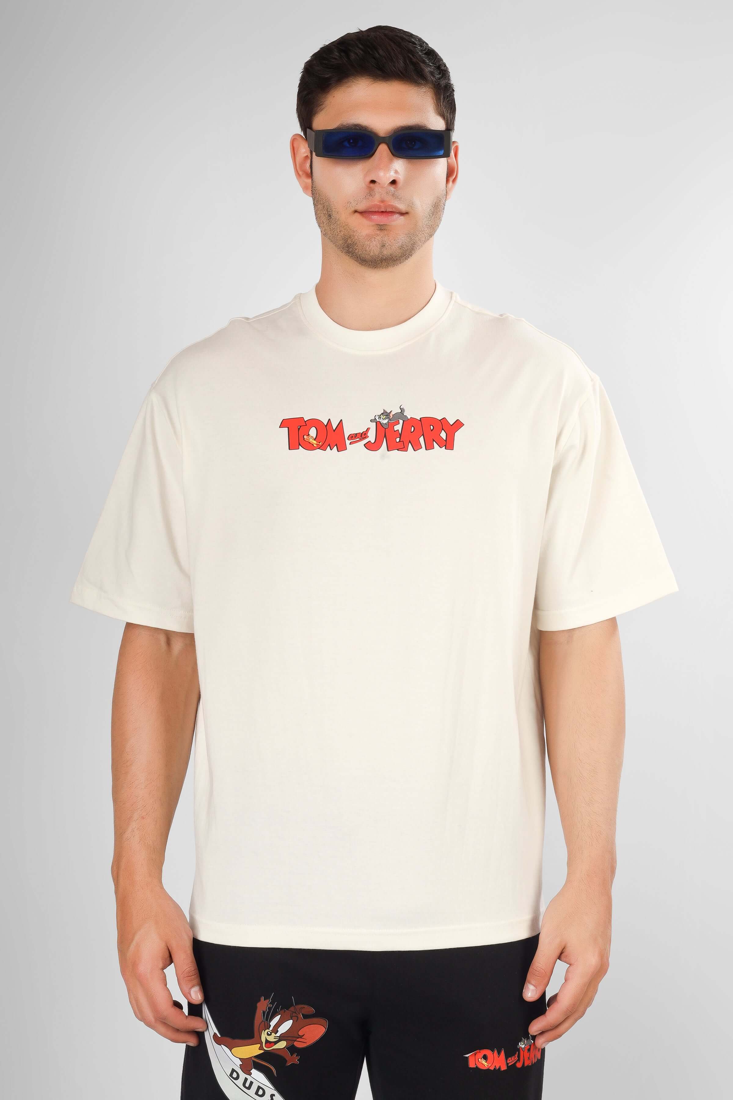 TOM & JERRY OVER-SIZED T-SHIRT CREAM featuring premium heavy gauge fabric, 100% cotton, worn by a model with sunglasses.